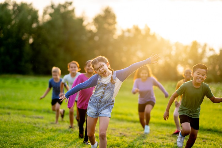 kids running in field in summer