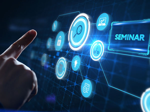 Hand pointing at a futuristic digital interface with icons and a highlighted “SEMINAR” label